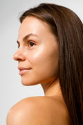 A close-up image of a person displaying the results of a cosmetic treatment on the face.