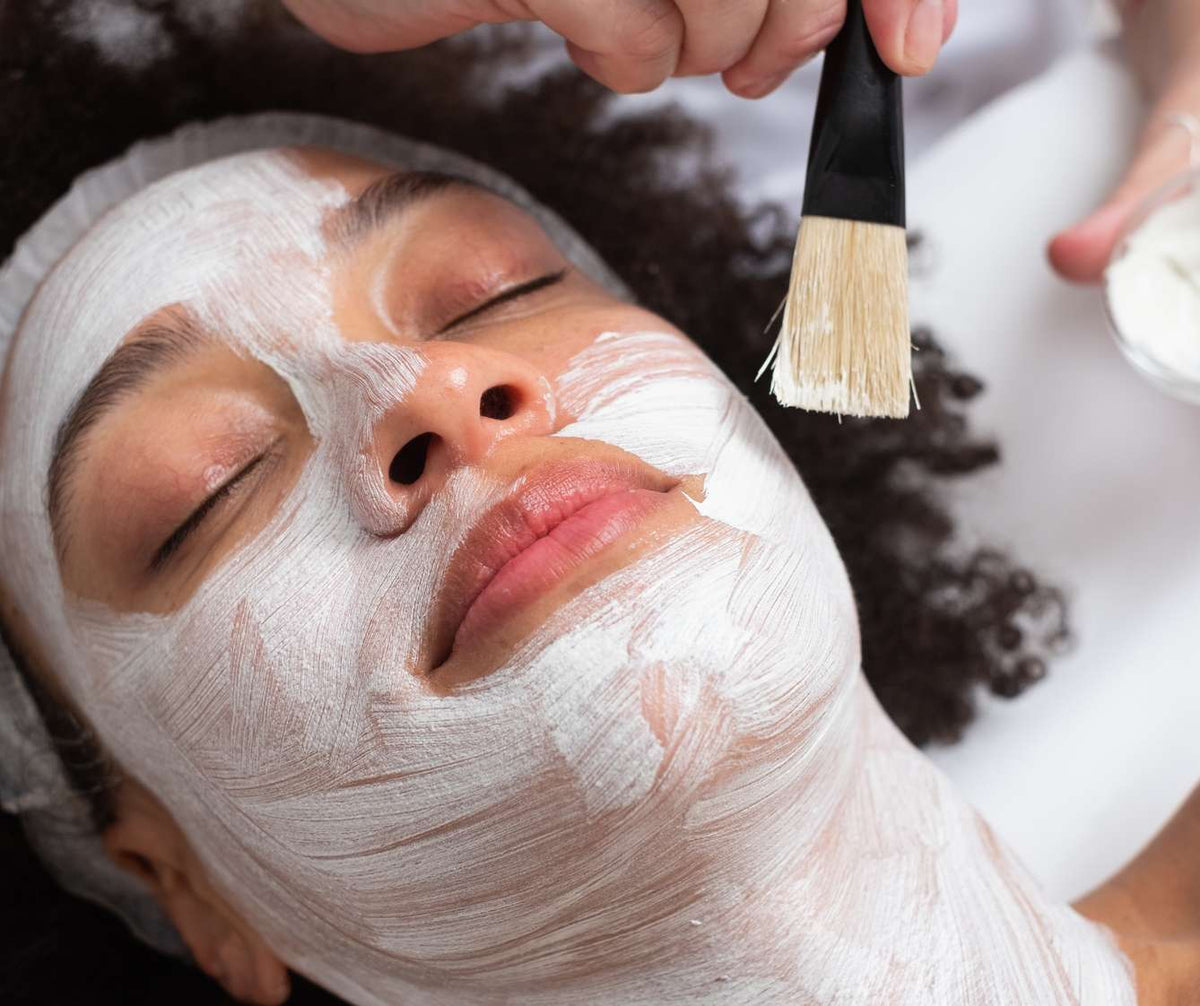 A client relaxing during a facial mask treatment
