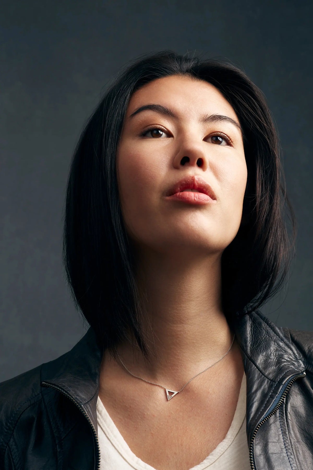 Woman in a leather jacket with her chin and neck highlighted